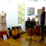 Martin speaking from the Kauge corner at the opening. The bilum dress by Vicki Kinai from PNG titled FIRST CONTACT, is to the left close to edge of the colourful work from the Australian Tapestry Workshop. Photo :  Sahra Stolz